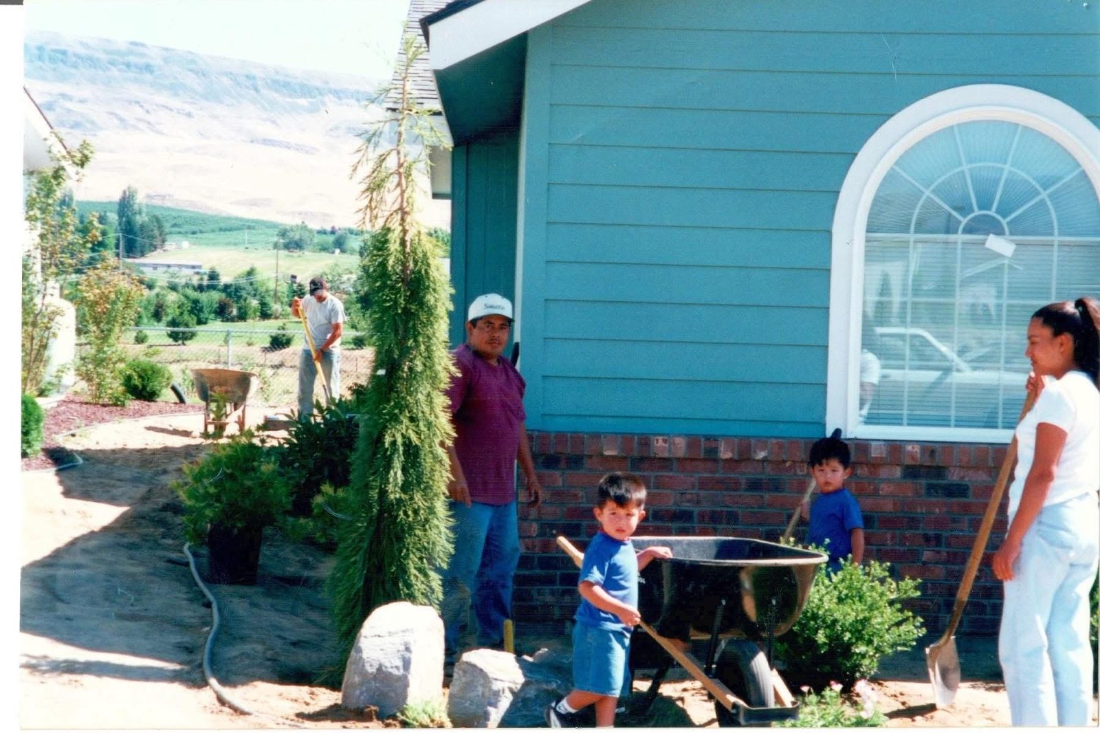 The Twins Landscaping family working together on a yard in the Wenatchee Valley